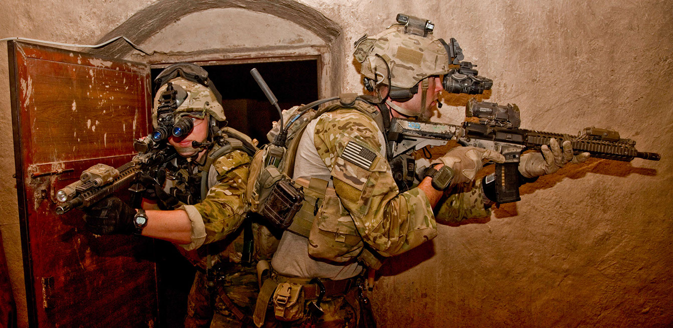 Photo of US Army Special Forces operatives entering a building in Afghanistan using night vision goggles.